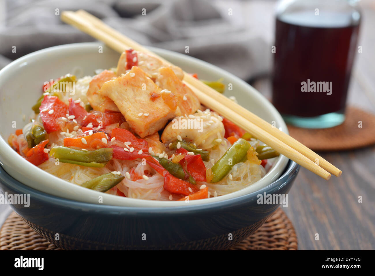 Rice noodles with chicken and vegetables in bowl closeup Stock Photo