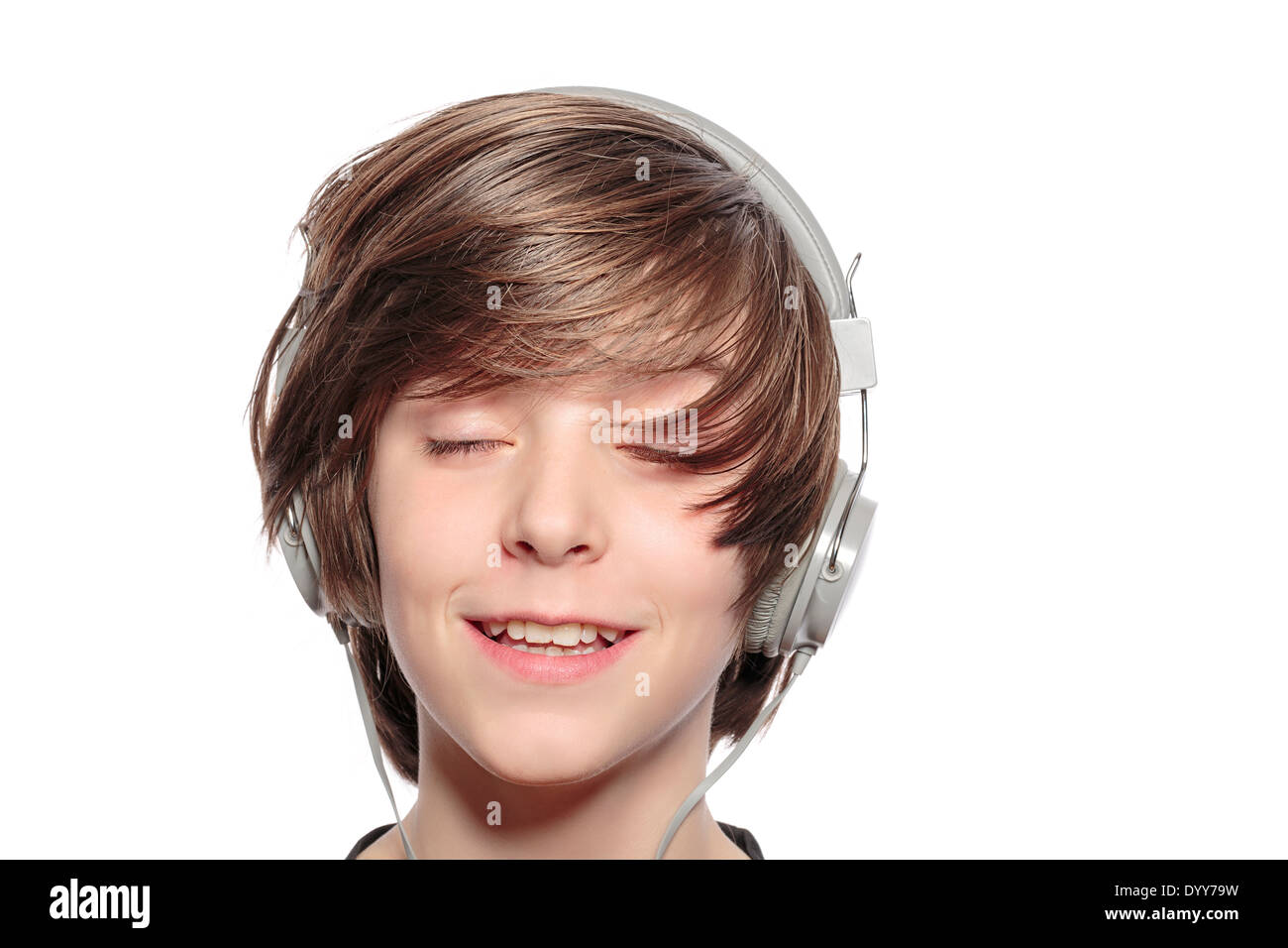 smiling cute teenager boy with headphones, isolated on white. Stock Photo