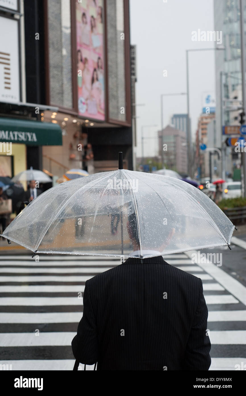 Man with umbrella in Aoyama, Tokyo, Japan Stock Photo