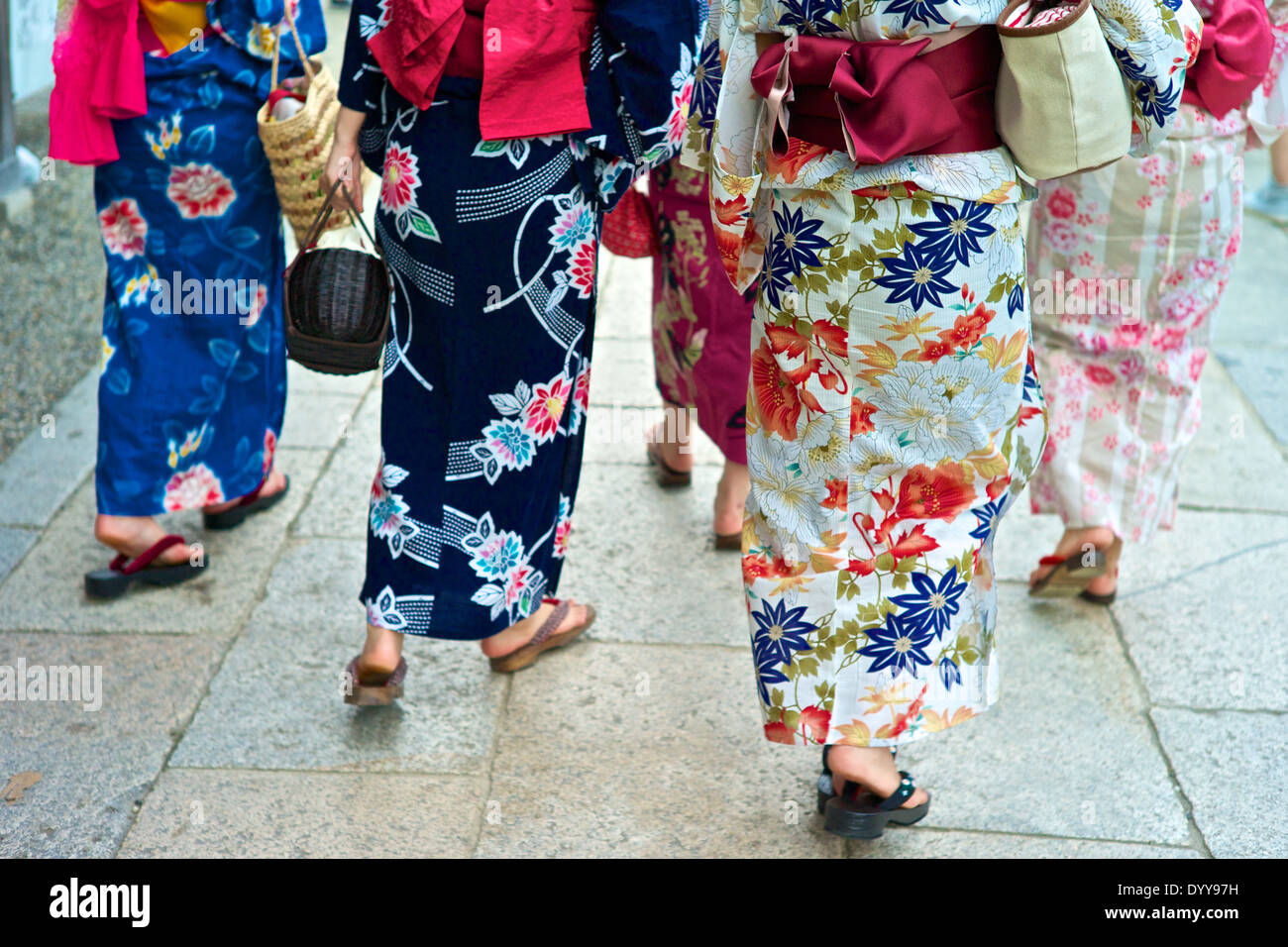 Asian women in traditional kimonos exploring the stores and shops near the Kiyomizu Temple. Stock Photo
