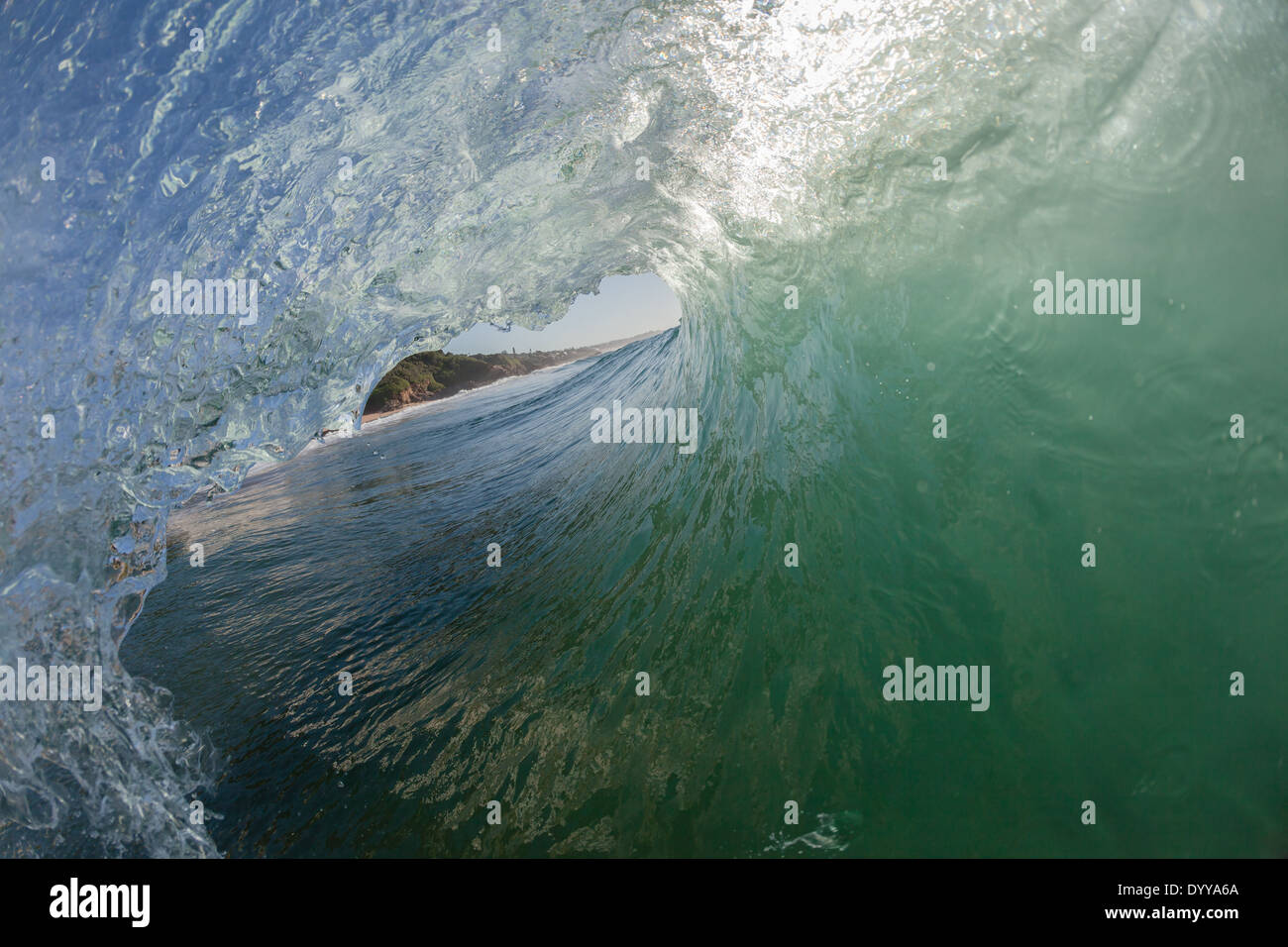 Ocean Wave swimming inside out closeup encounter hollow crashing water power. Stock Photo