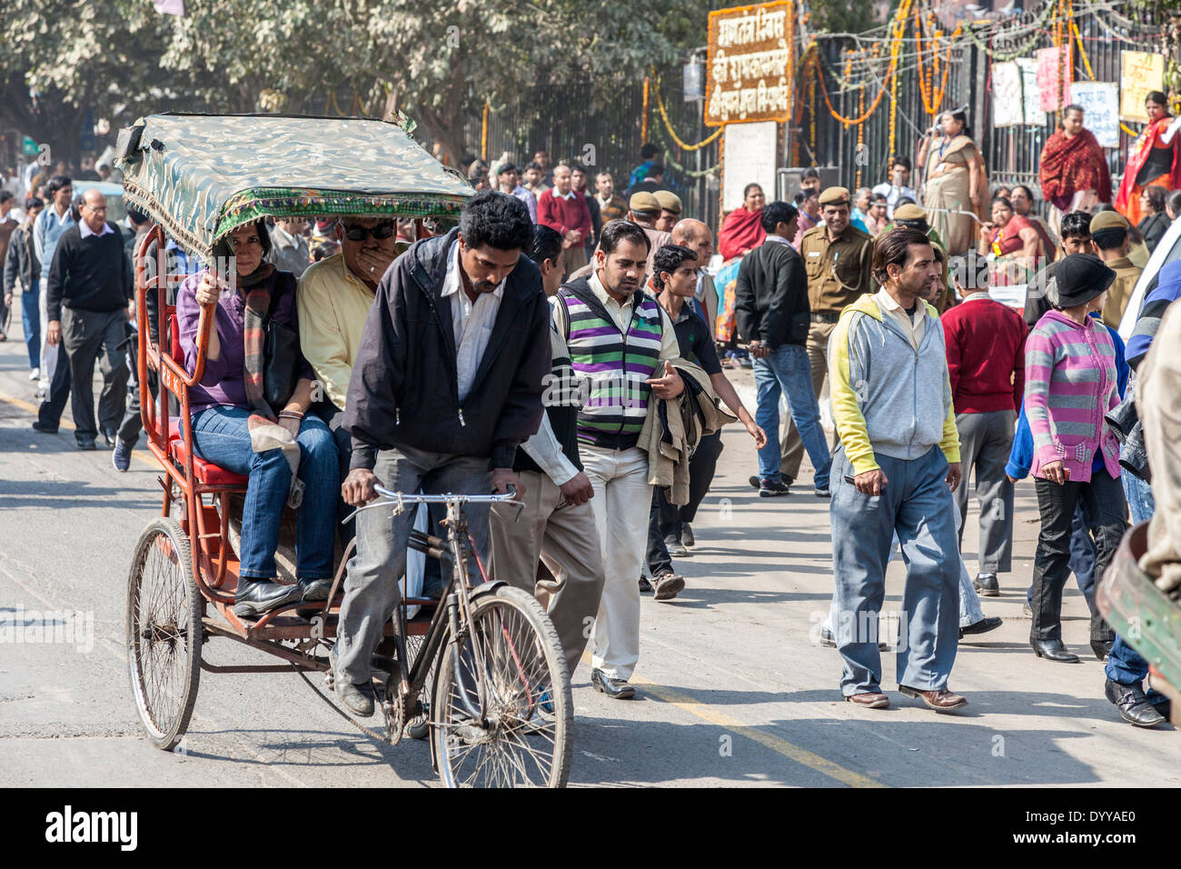 New Delhi, India. Rickshaw Driver and his Passengers, Street Scene. Stock Photo