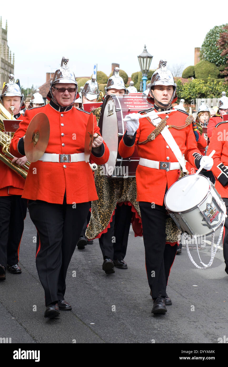 Marching brass band walking down the high street in stratford hires