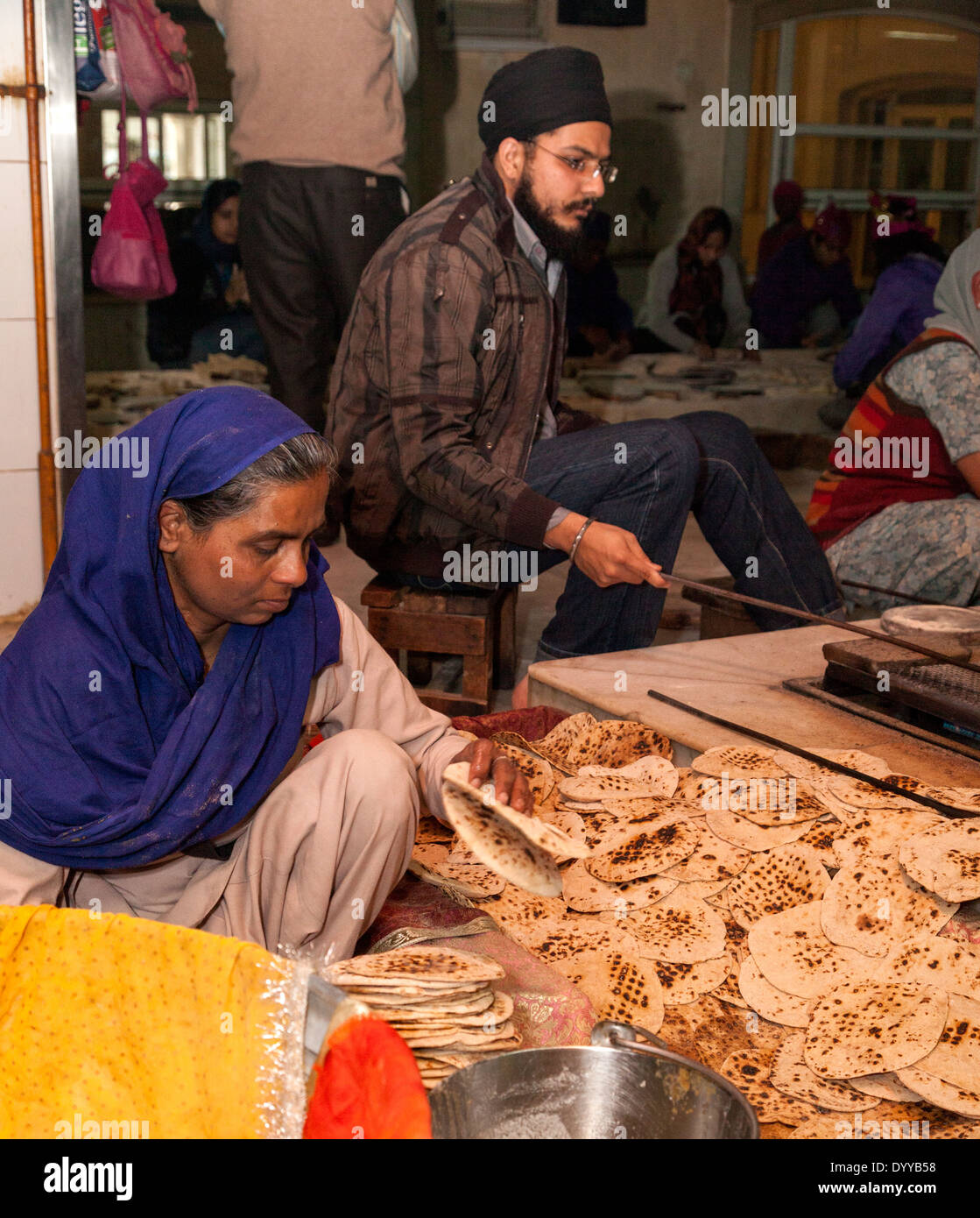 New Delhi, India. Sikhs Preparing Chapatis (an Unleavened Bread) for the Evening Meal offered to the Hungry. Stock Photo