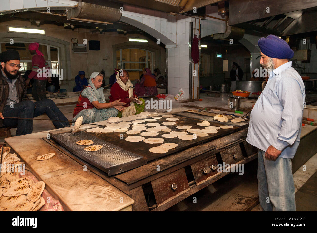 New Delhi, India. Sikhs Preparing Chapatis (an Unleavened Bread) for the Evening Meal offered to the Hungry. Stock Photo