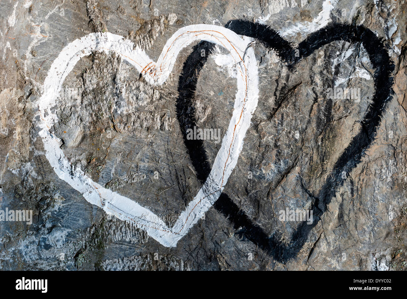 Two intertwined hearts painted on a rock face Stock Photo
