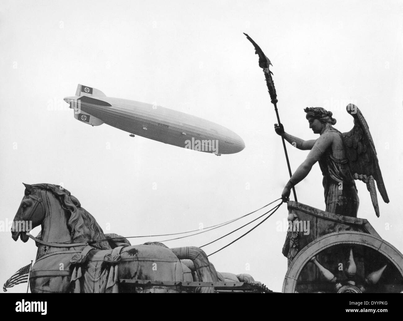 Zeppelin Hindenburg (LZ 129) and the Brandenburg Gate in Berlin during the Olympics 1936 Stock Photo