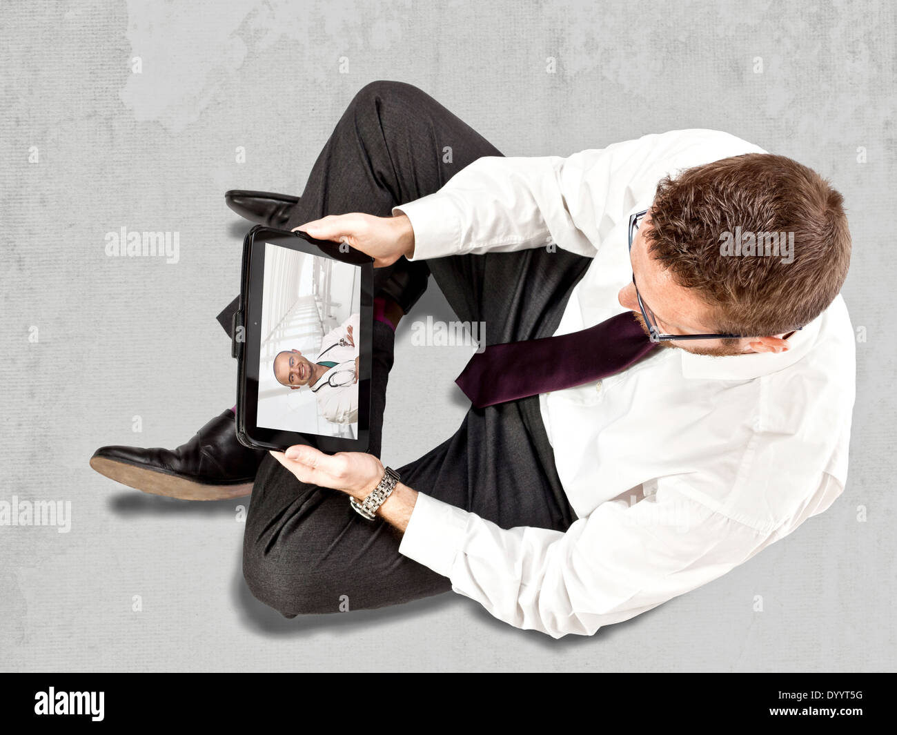 man use tablet to contact doctor Stock Photo