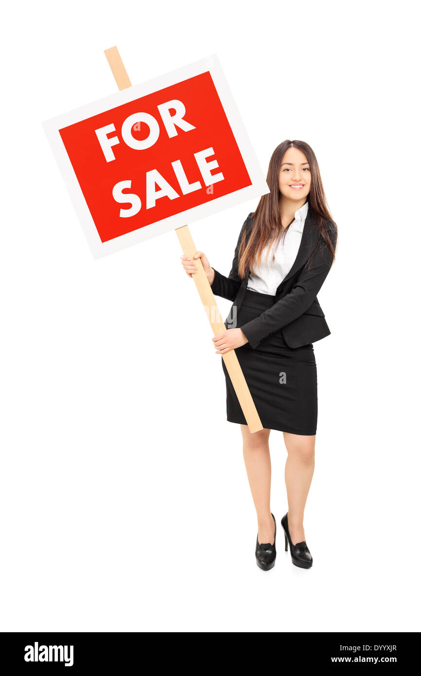 Female real estate agent holding a for sale sign Stock Photo - Alamy