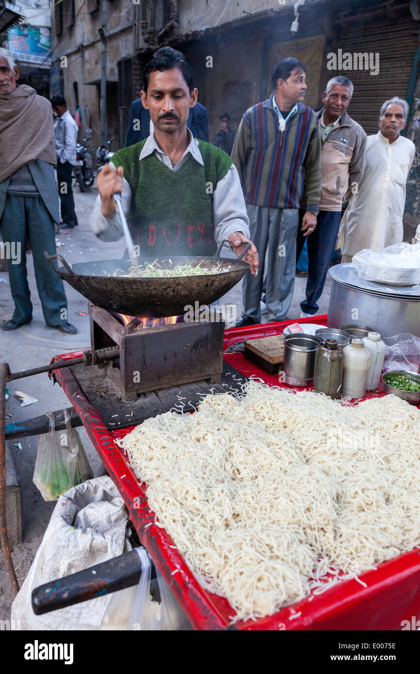 New Delhi, India. Street Food Vendor Cooking Cabbage, Spaghetti in Front. Stock Photo