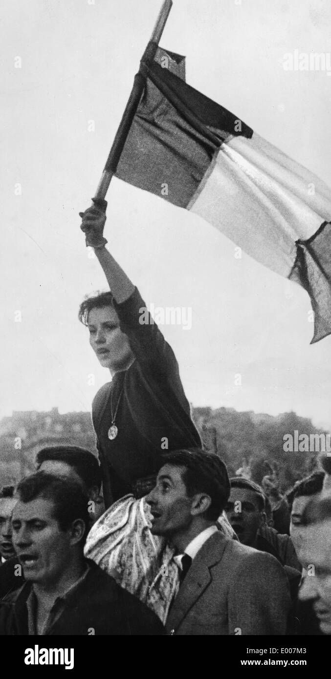A woman waves the flag of France at a demonstration in Paris, 1958 Stock Photo