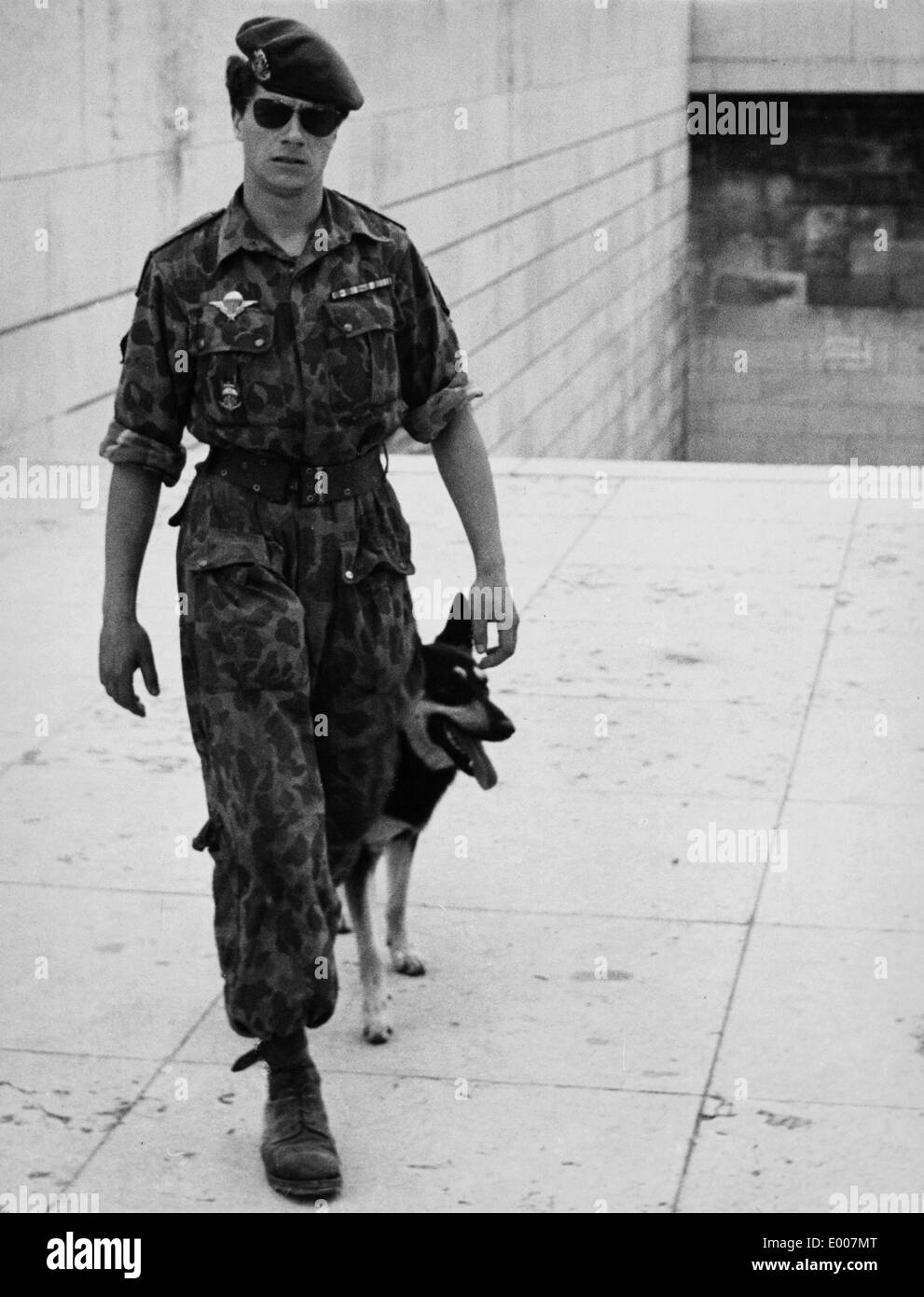 A soldier with dog in Paris, 1959 Stock Photo
