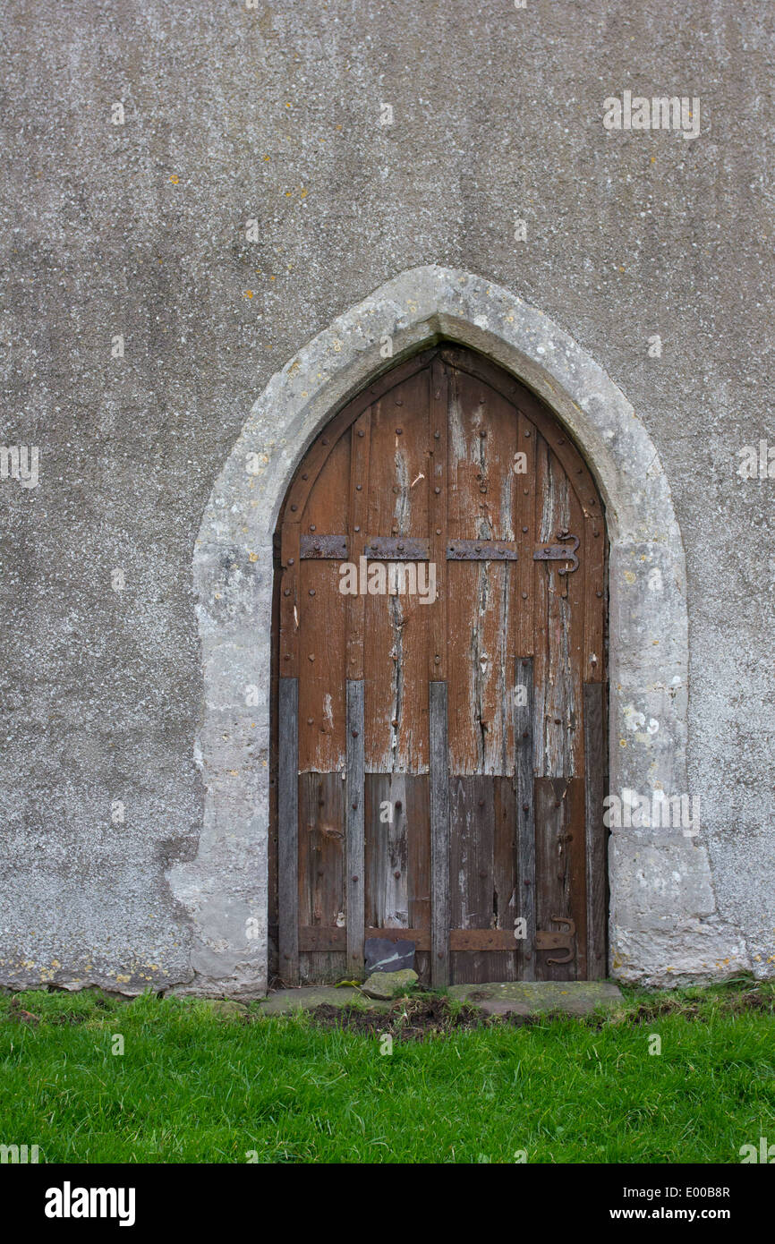 A beautiful wooden door on a medieval stone church in England Stock Photo