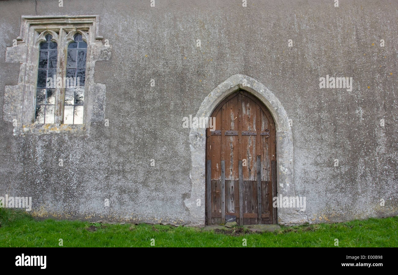 A beautiful medieval church window and wooden door Stock Photo