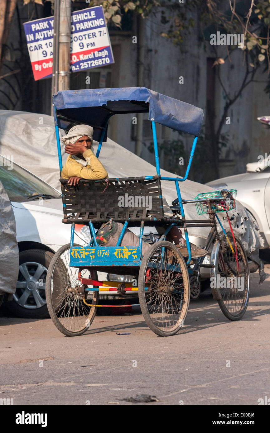 New Delhi, India. Rickshaw Driver Waiting for a Passenger. Stock Photo