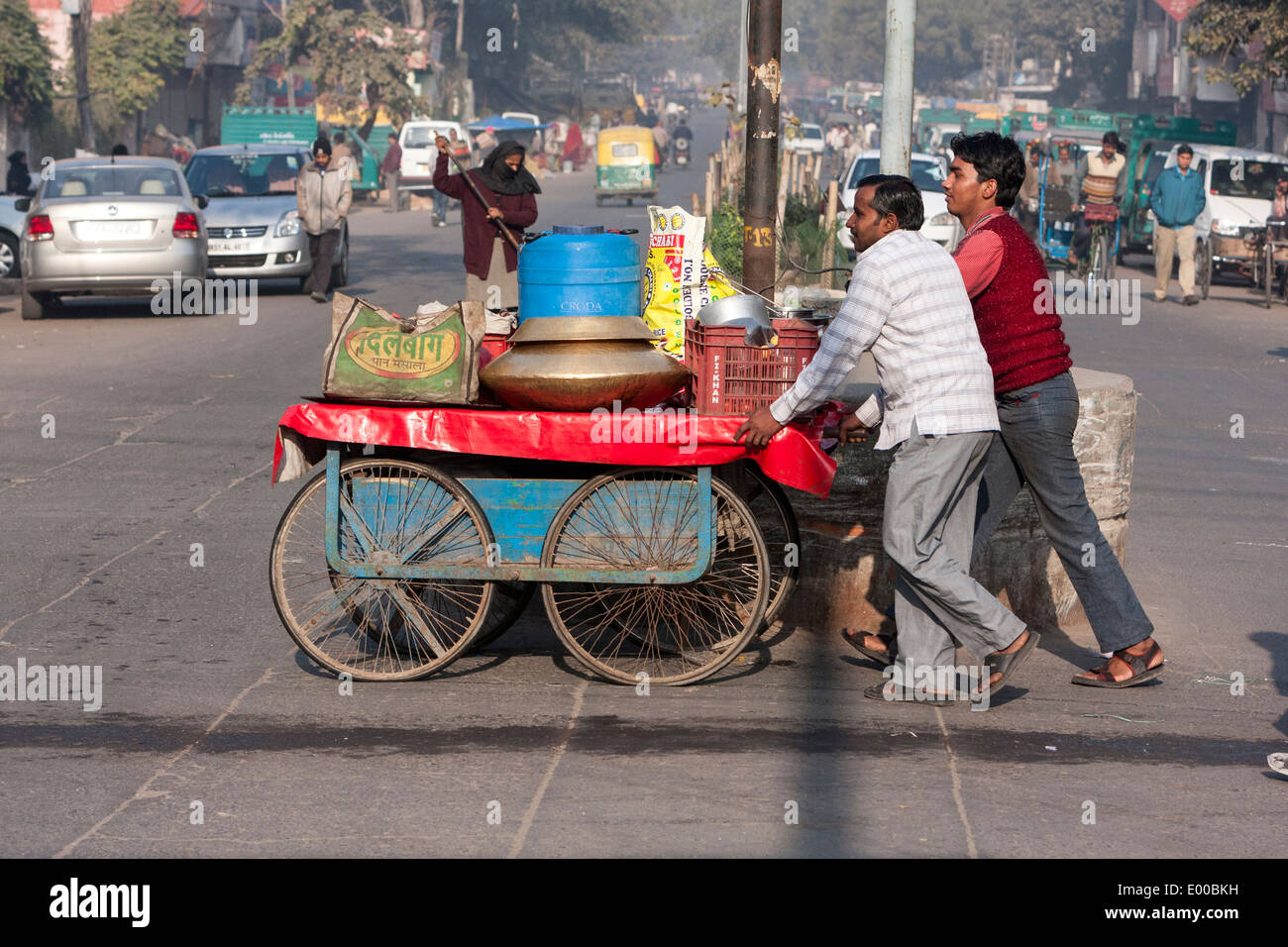 New Delhi, India. Two Men Pushing a Food Vendor's Cart. Stock Photo