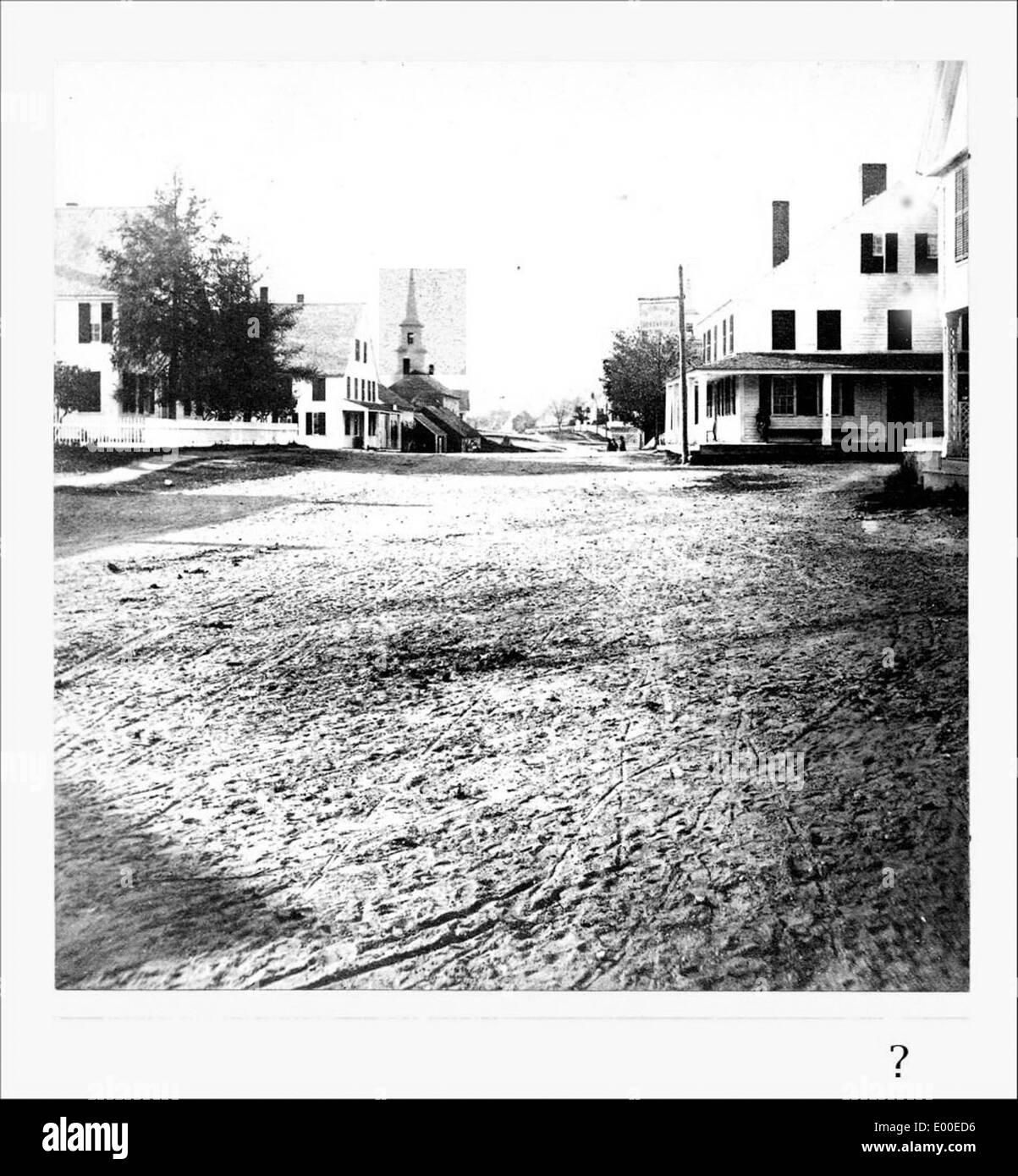 A photo of an unknown street in Keene, New Hampshire, featuring a dirt road lined with houses, including a residence owned by J.A. French. The rural scene reflects the area's historical landscape. Stock Photo