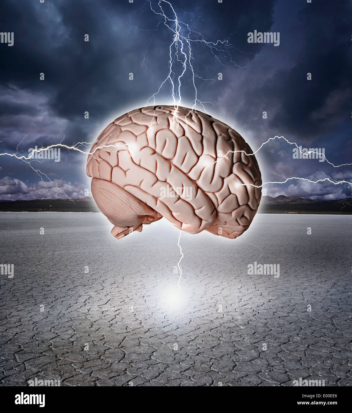 Brain being shocked with lightning over a dry lake bed. Stock Photo