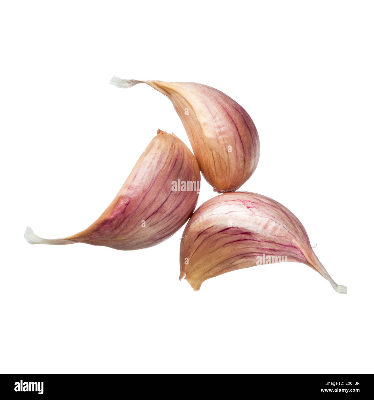 Three garlic cloves isolated on white background Stock Photo