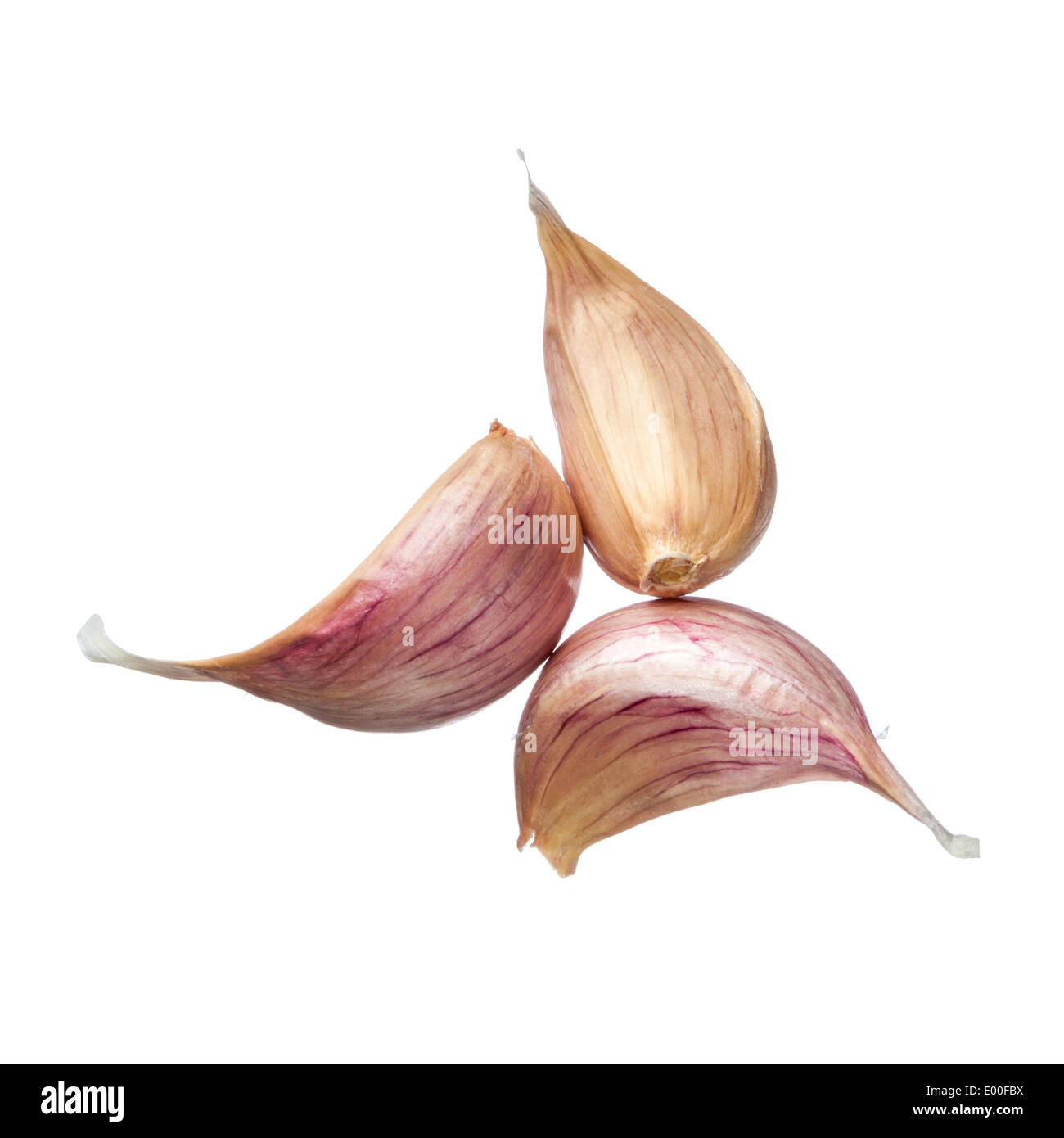 Three garlic cloves isolated on white background Stock Photo - Alamy