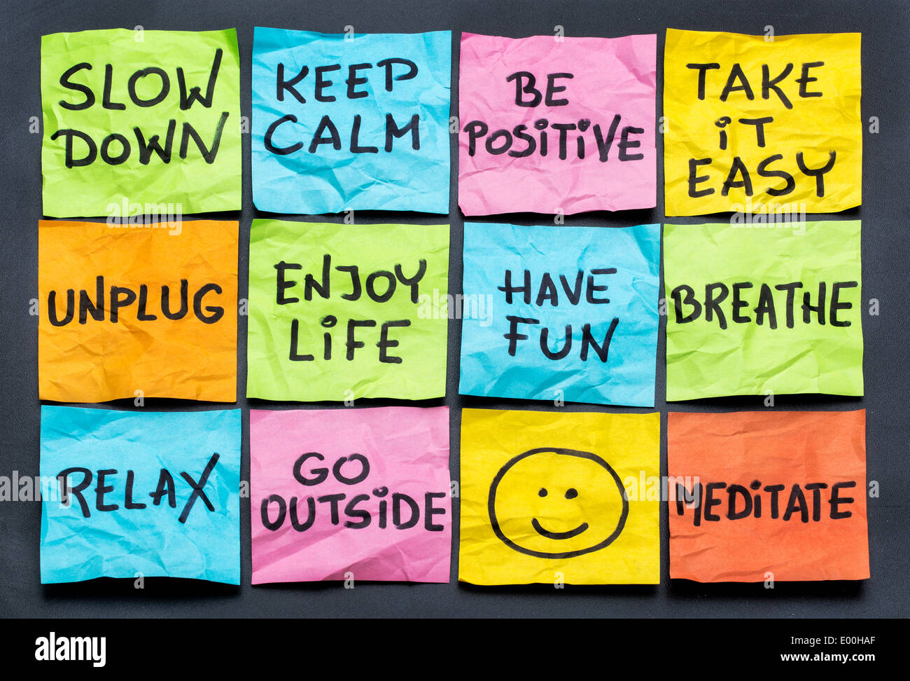 slow down, relax, take it easy, keep calm and other motivational lifestyle reminders on colorful sticky notes Stock Photo