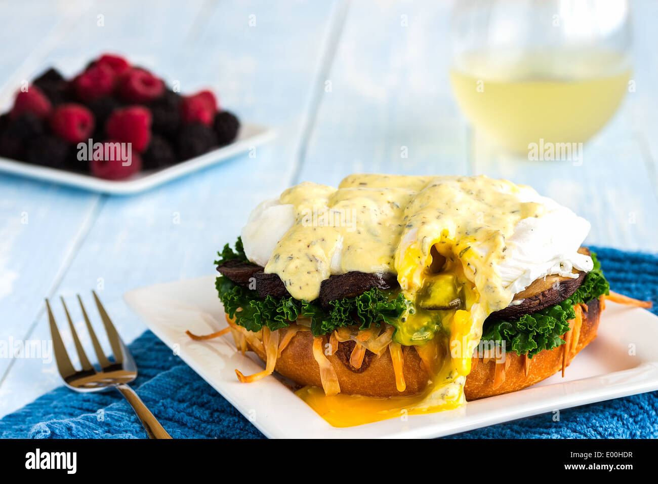 Vegetarian eggs benedict made with gouda cheese, steamed kale, sauteed