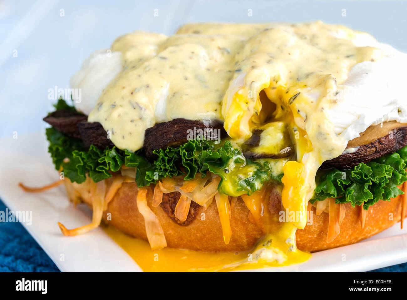 Vegetarian eggs benedict made with gouda cheese, steamed kale, sauteed