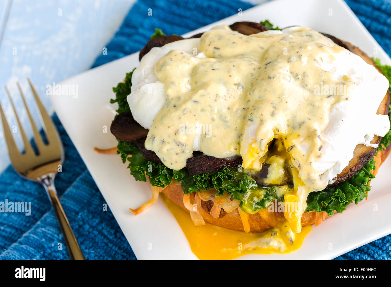 Vegetarian eggs benedict made with gouda cheese, steamed kale, sauteed