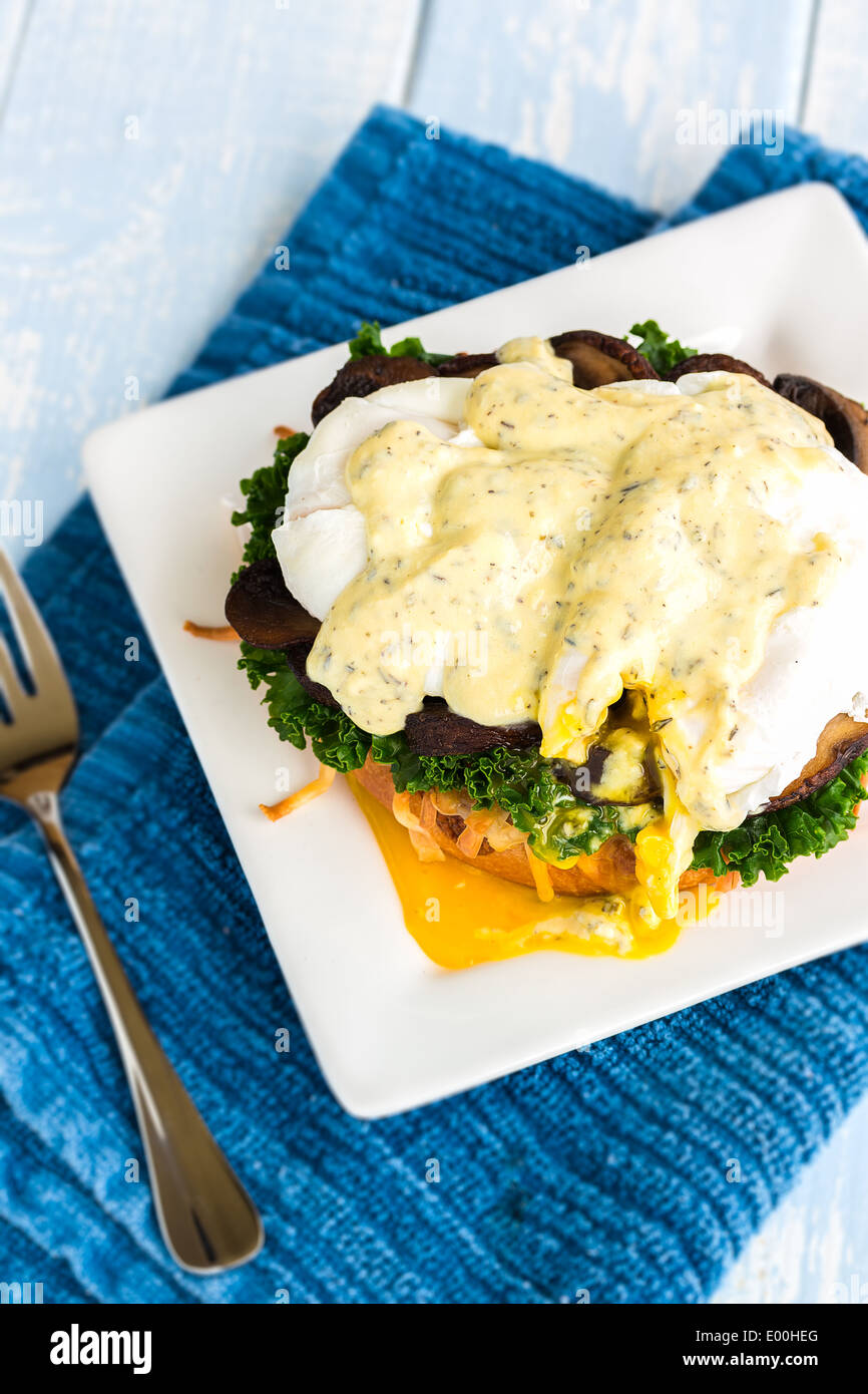 Vegetarian eggs benedict made with gouda cheese, steamed kale, sauteed
