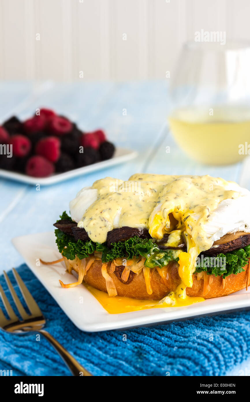 Vegetarian eggs benedict made with gouda cheese, steamed kale, sauteed