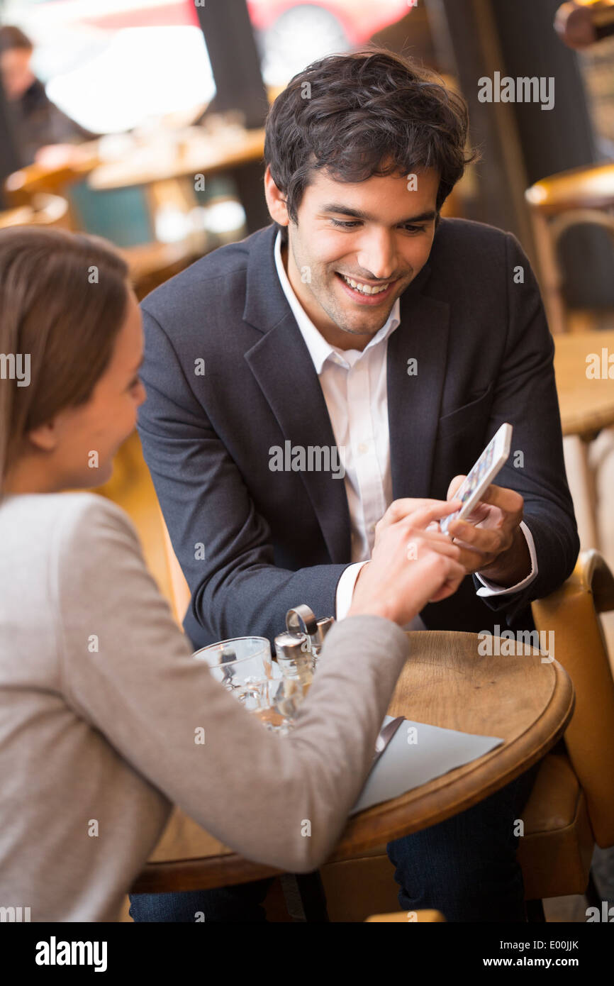 Man woman using cell phone coffee bar Stock Photo