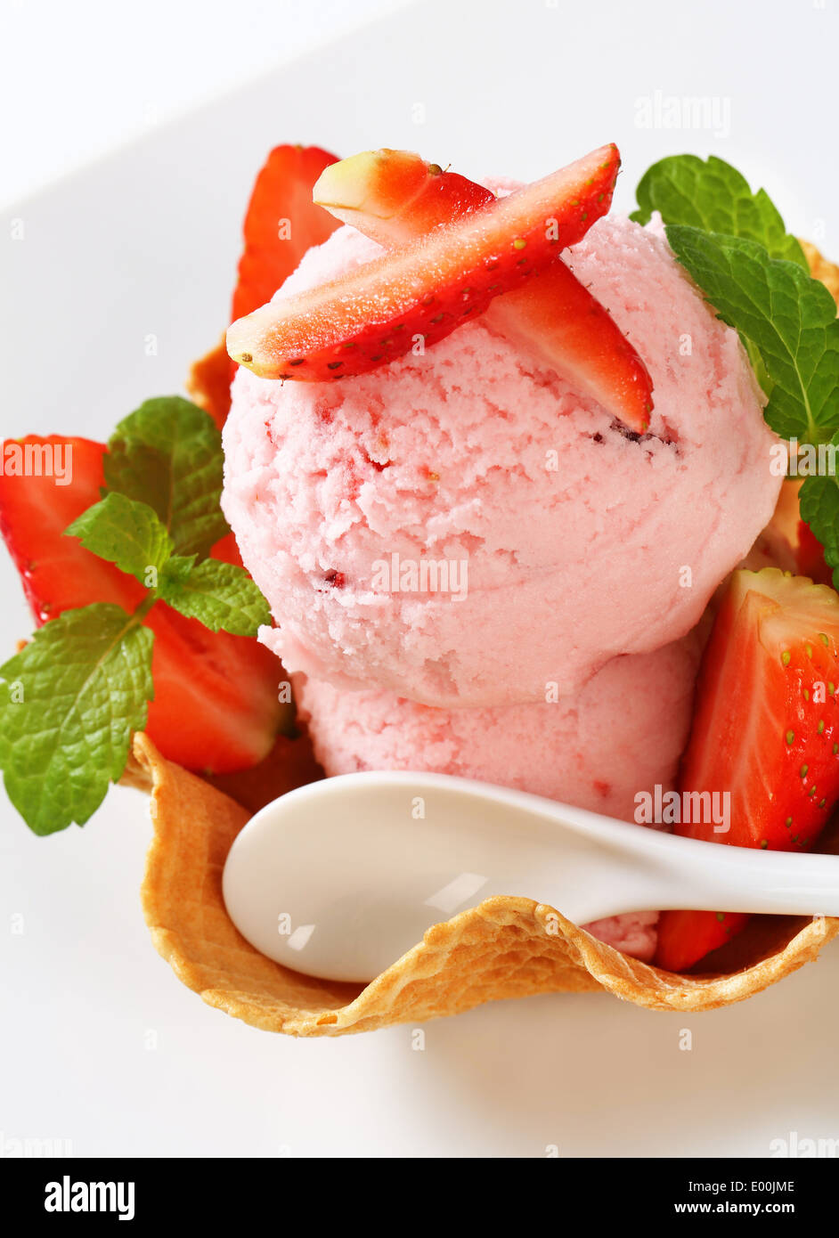 Scoops of strawberry ice cream in waffle basket Stock Photo