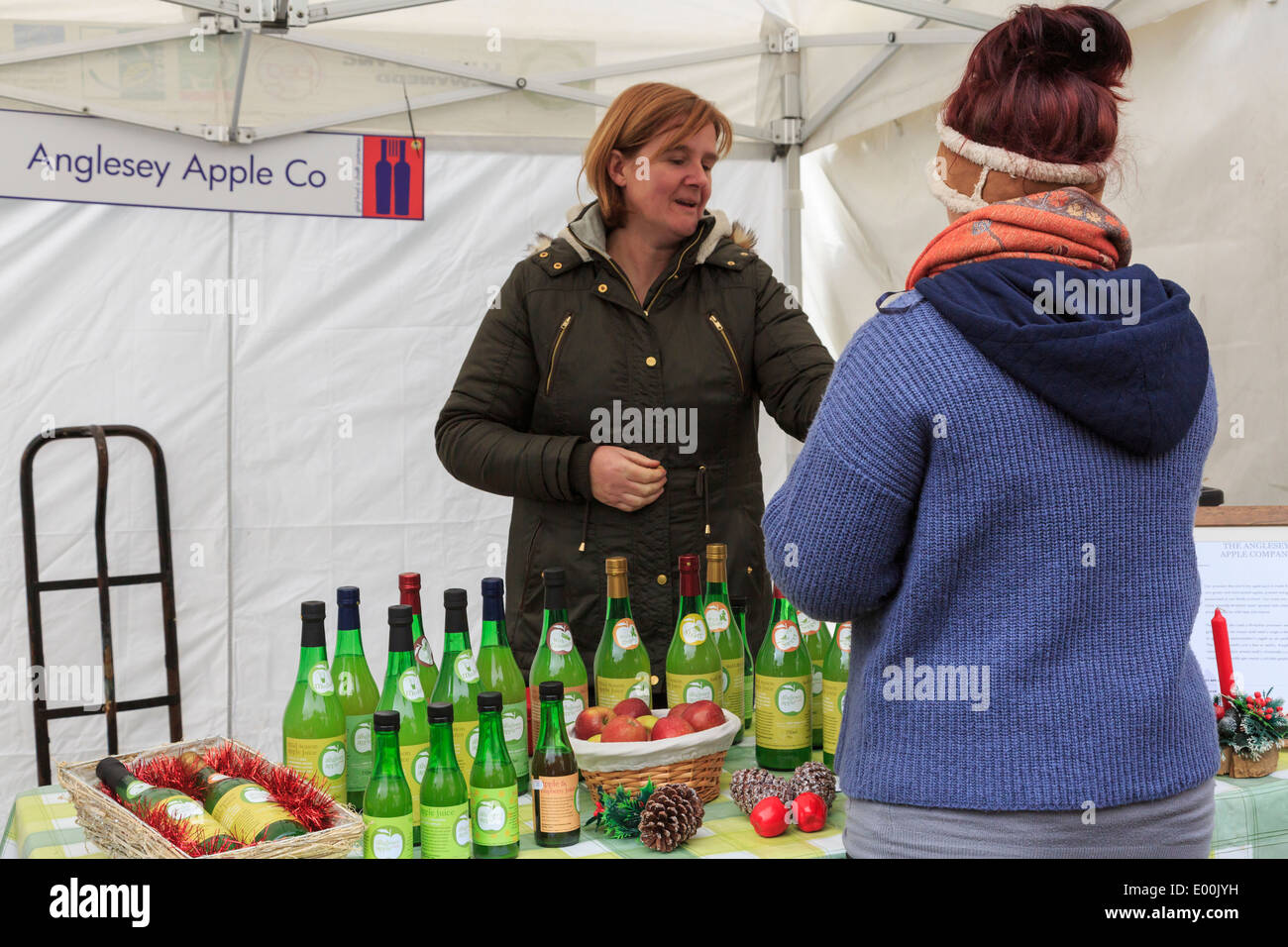 Anglesey Apple Company stall selling fruit drinks at Christmas Food and Craft Fair in Portmeirion Gwynedd Wales UK Britain Stock Photo