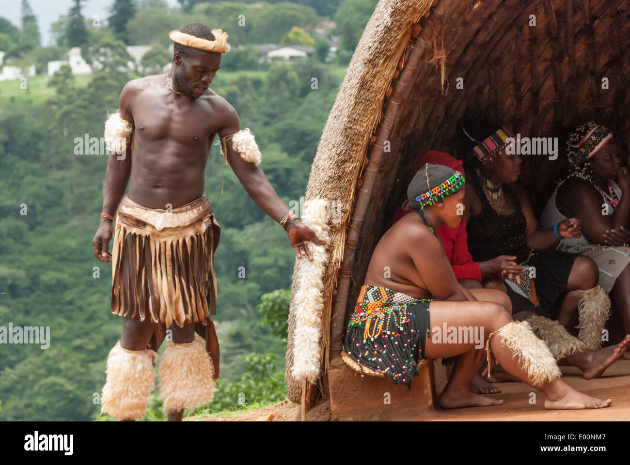 Zulu male and female in traditional dress performing for the public at Phezulu Village Park in Kwazulu Natal South Africa Stock Photo