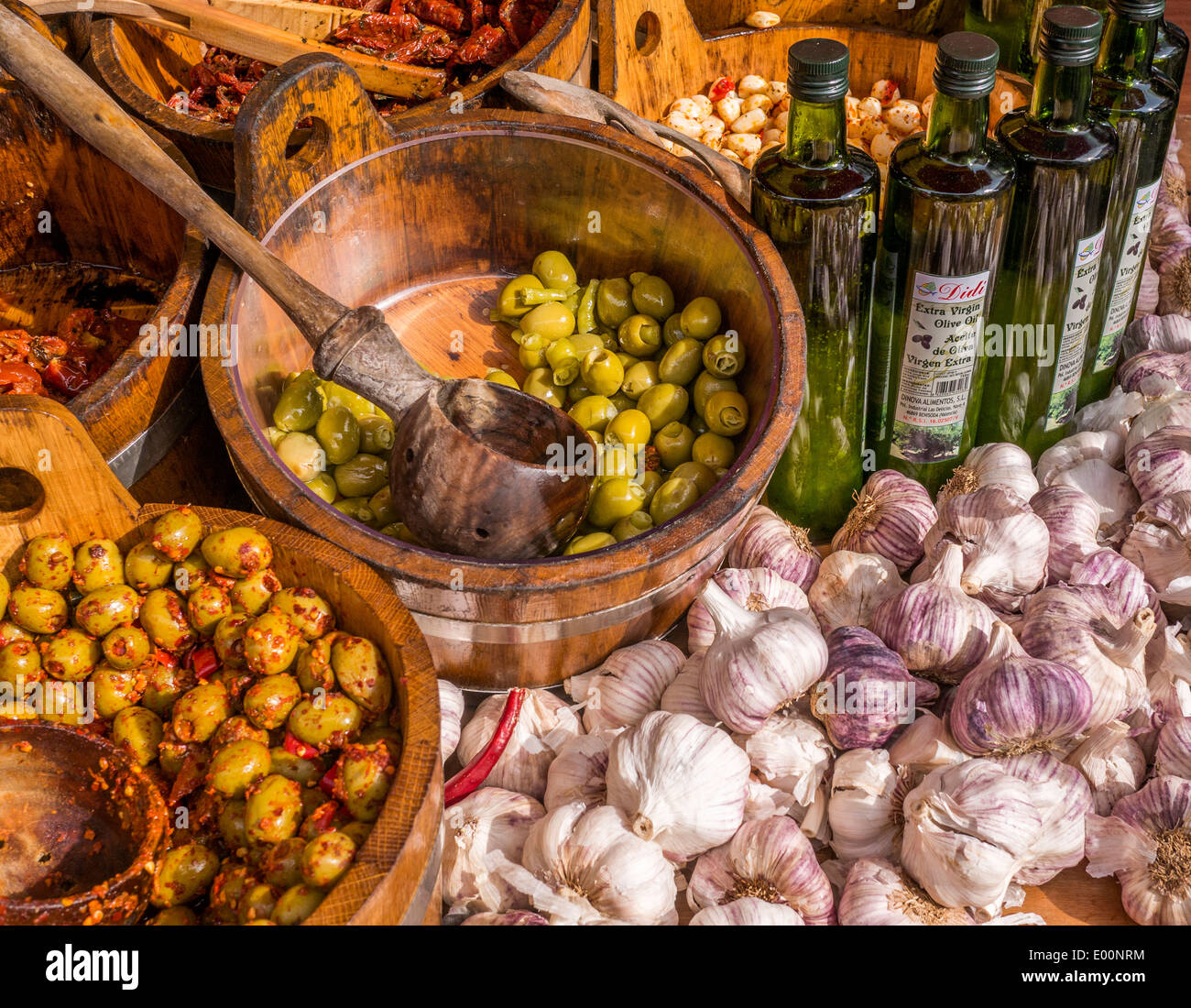 Olives, whole garlic cloves and olive oil Stock Photo Alamy