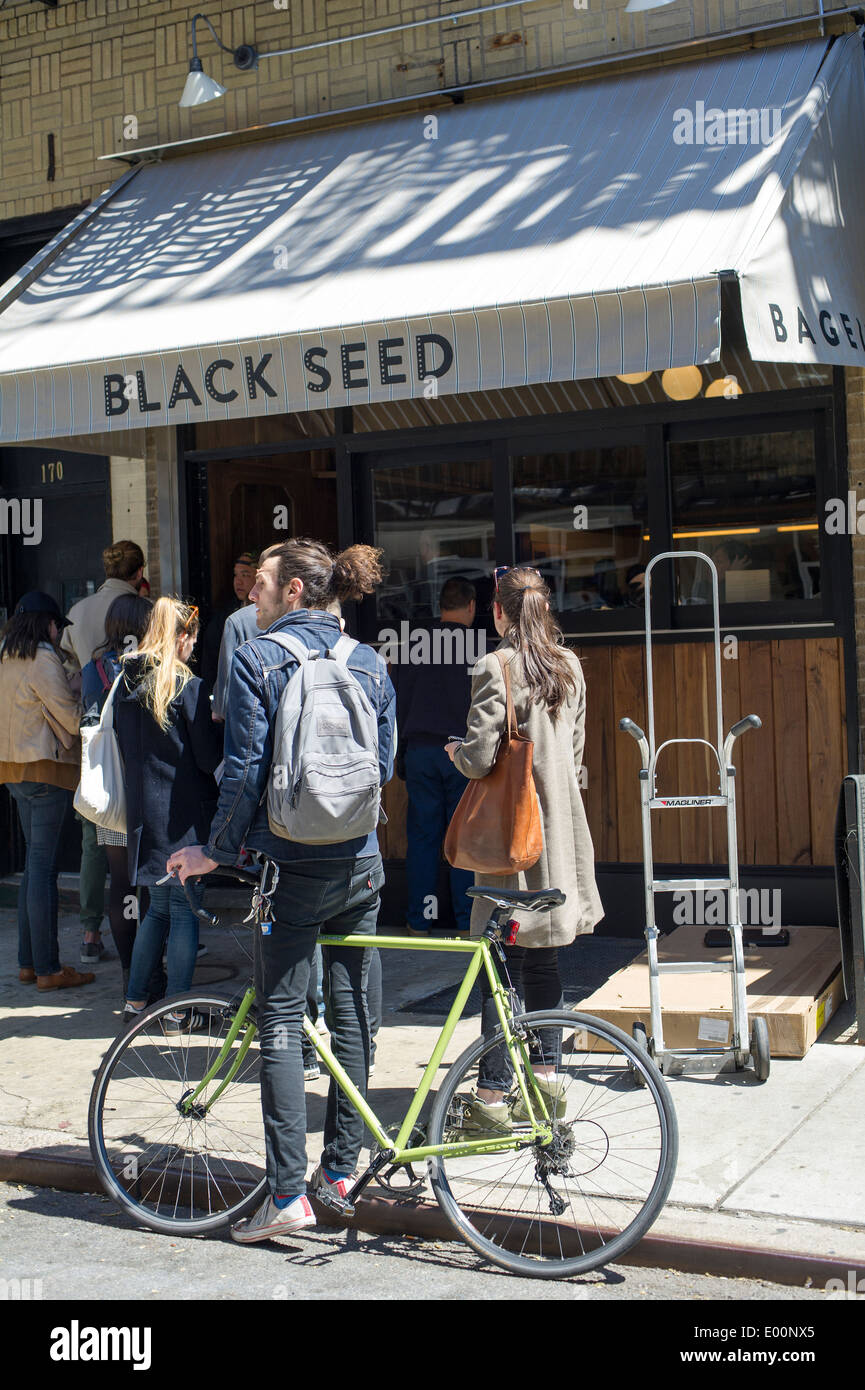 Customers wait outside for their Montreal style bagels at the Black Seed bagelry in Nolita in New York Stock Photo