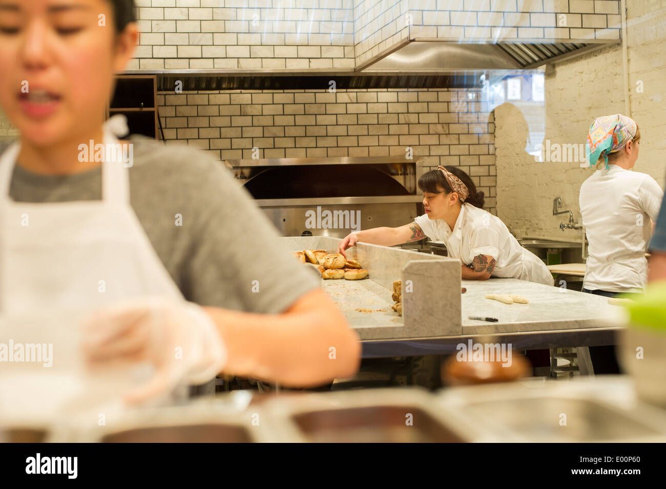 Workers prepare artisanal Montreal style bagels in the Black Seed bagelry in Nolita in New York Stock Photo