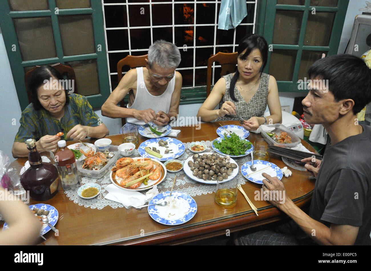 Vietnamese family eat a seafood dinner in their house Stock Photo