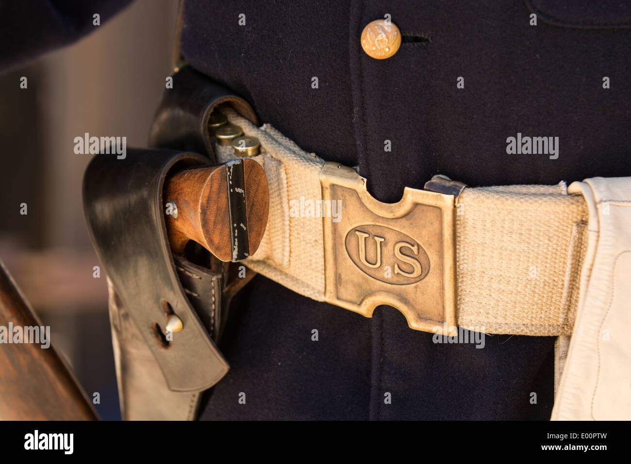 A gun belt, pistol and holster on the waist of an African American
