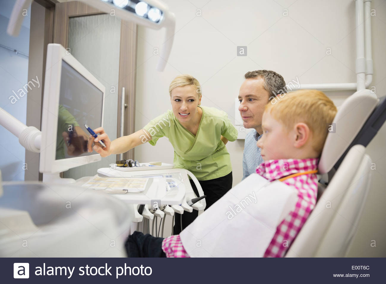 Dental assistant reviewing xrays with patient Stock Photo Alamy