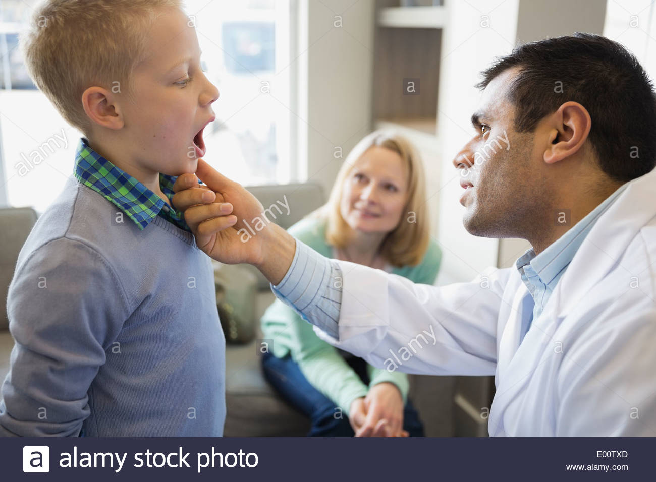 Dentist looking into boys mouth Stock Photo