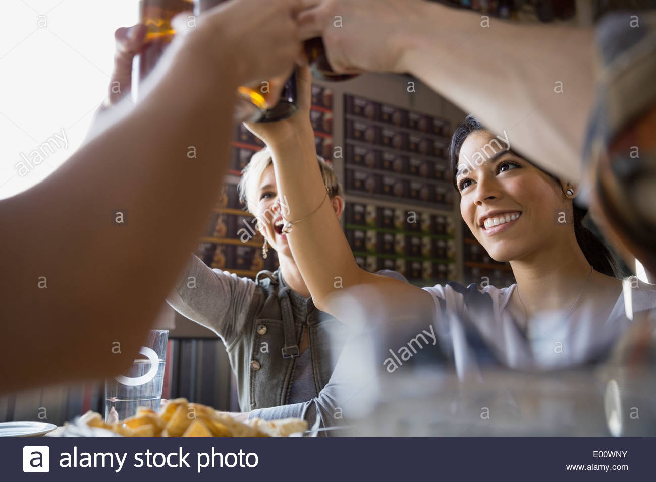 Friends toasting beer glasses at brewery Stock Photo