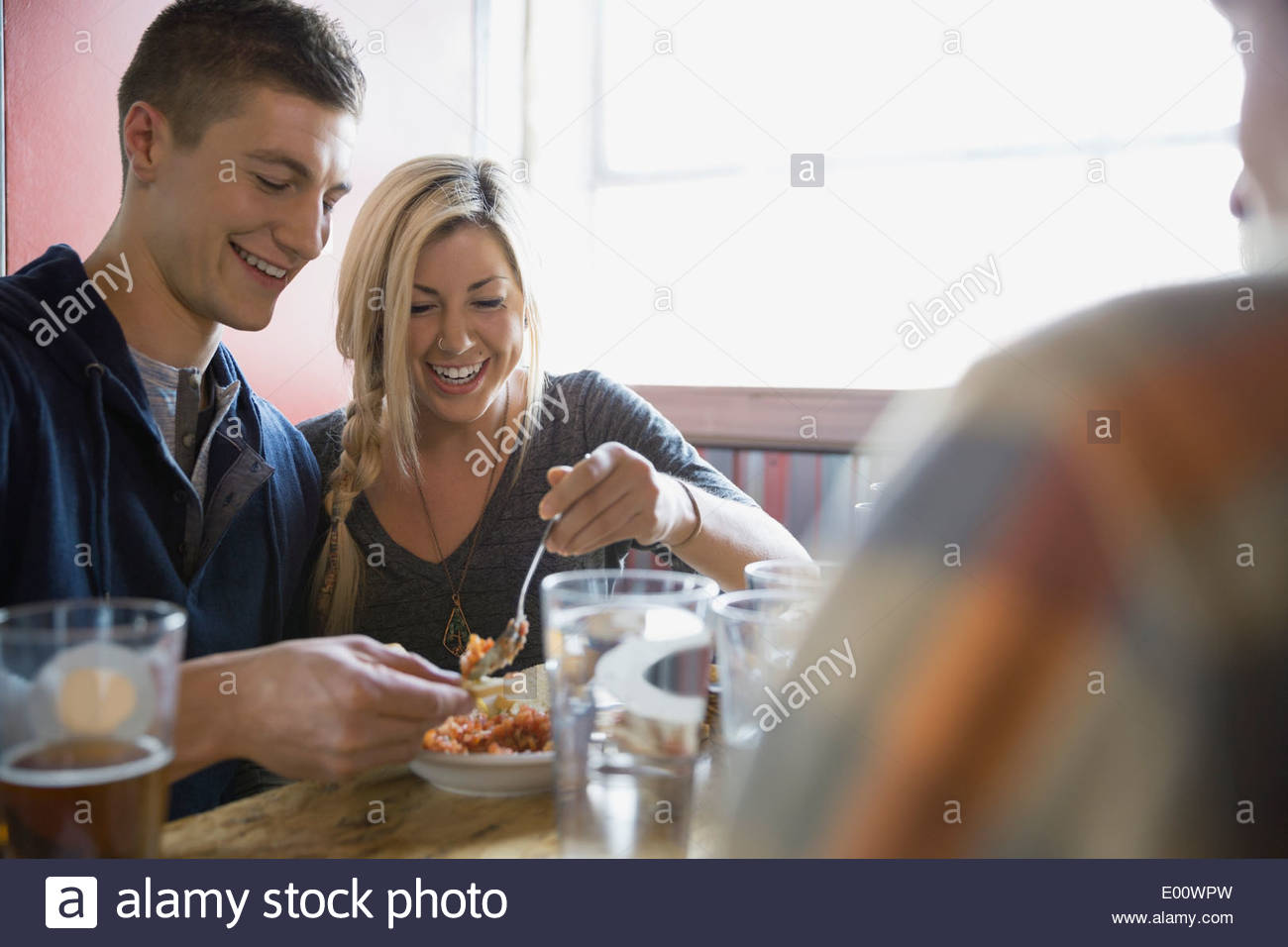 Couple sharing appetizer at brewery Stock Photo