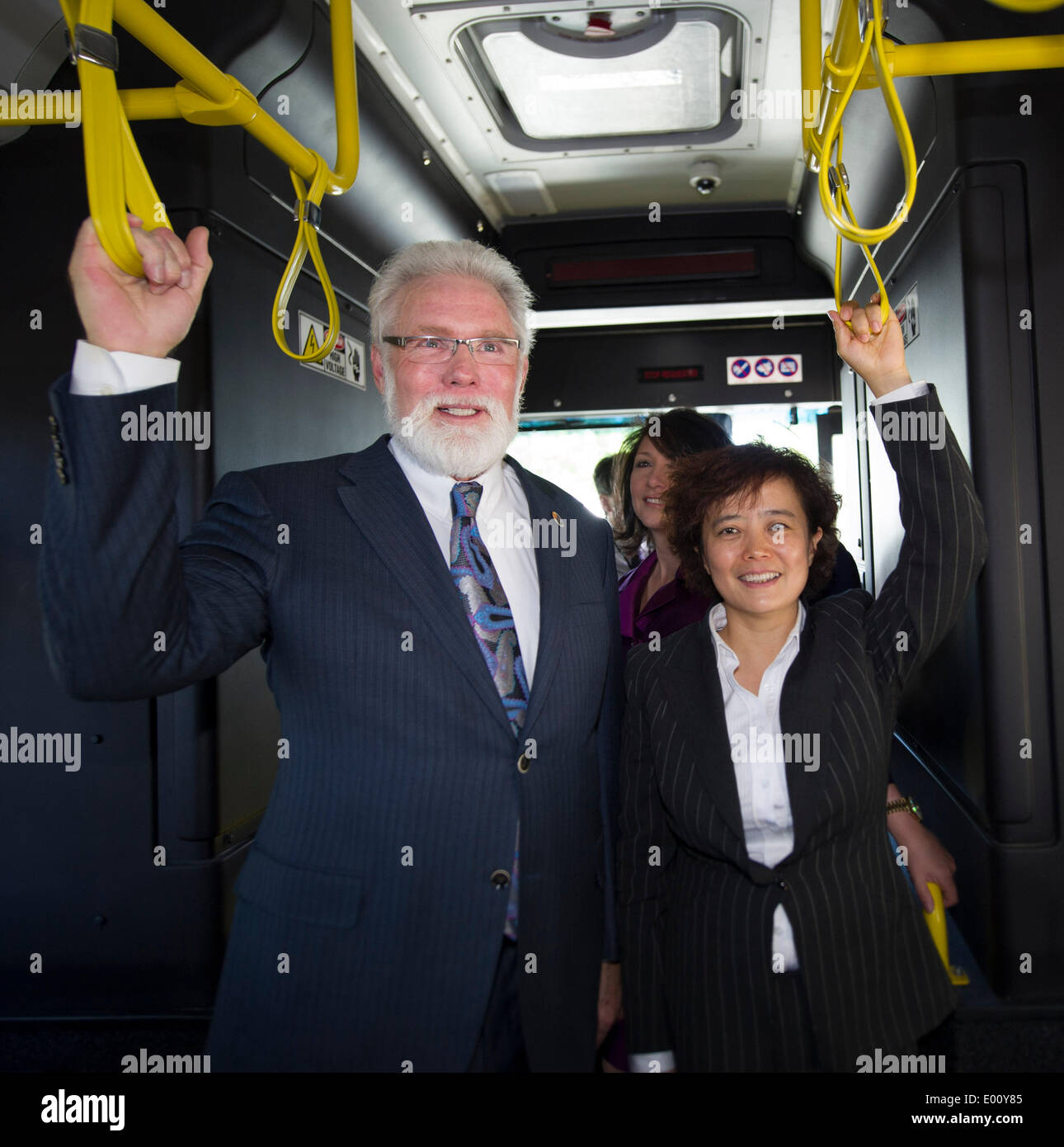 Lancaster, USA. 28th Apr, 2014. Lancaster Mayor Rex Parris and BYD Senior Vice President Li Ke (R) pose for pictures in the first American-made electric bus built at BYD's factory in Lancaster, California, the United States, April 28, 2014. BYD unveiled its first American-made long-range zero-emission electric bus during a ceremony held in Lancaster on Monday. Credit:  Yang Lei/Xinhua/Alamy Live News Stock Photo