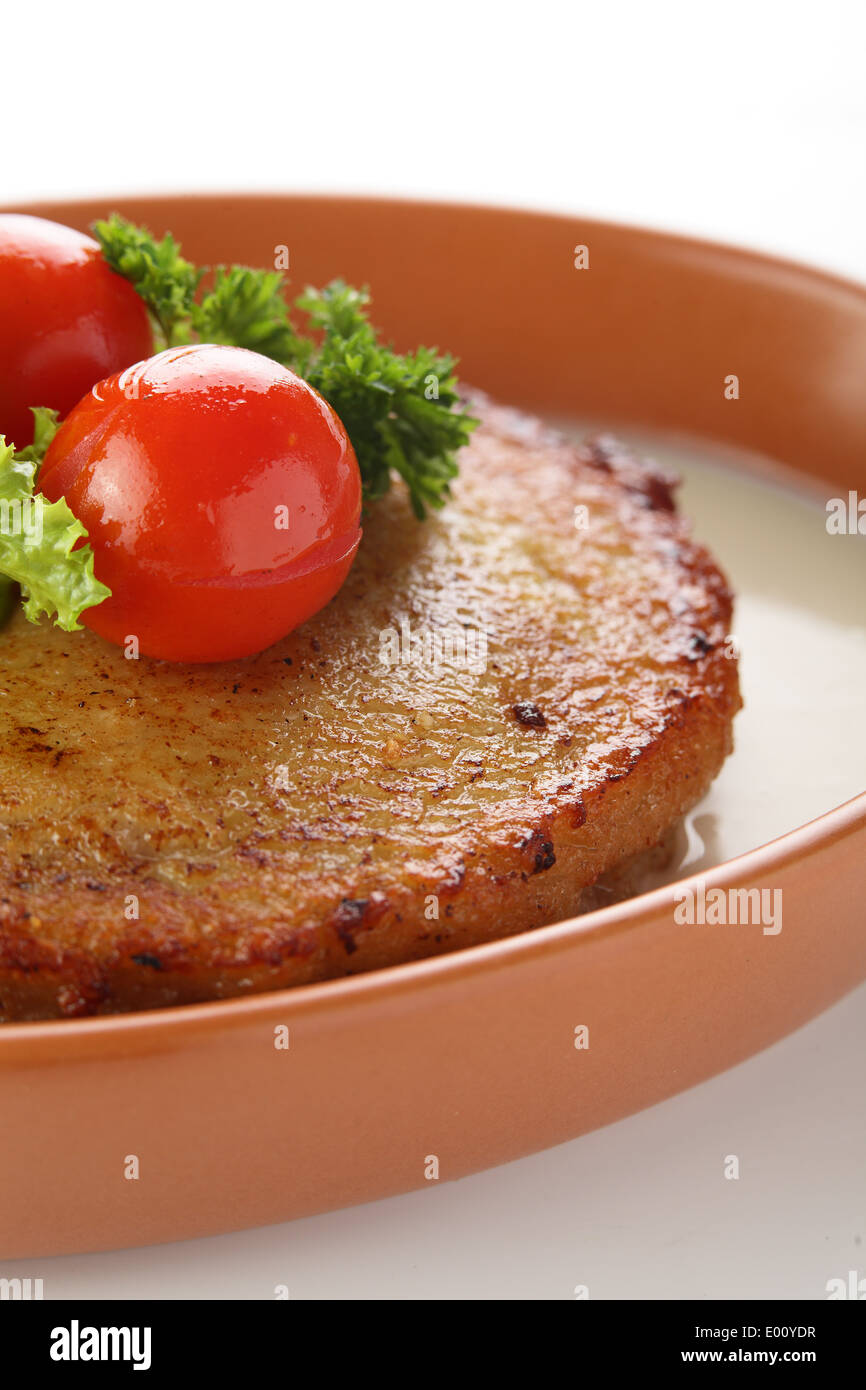 Hot pancake from potato with meat and tomato Stock Photo