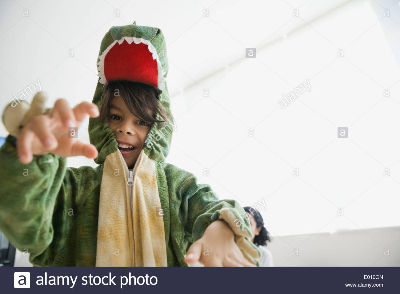 Playful boy in dragon costume Stock Photo Alamy