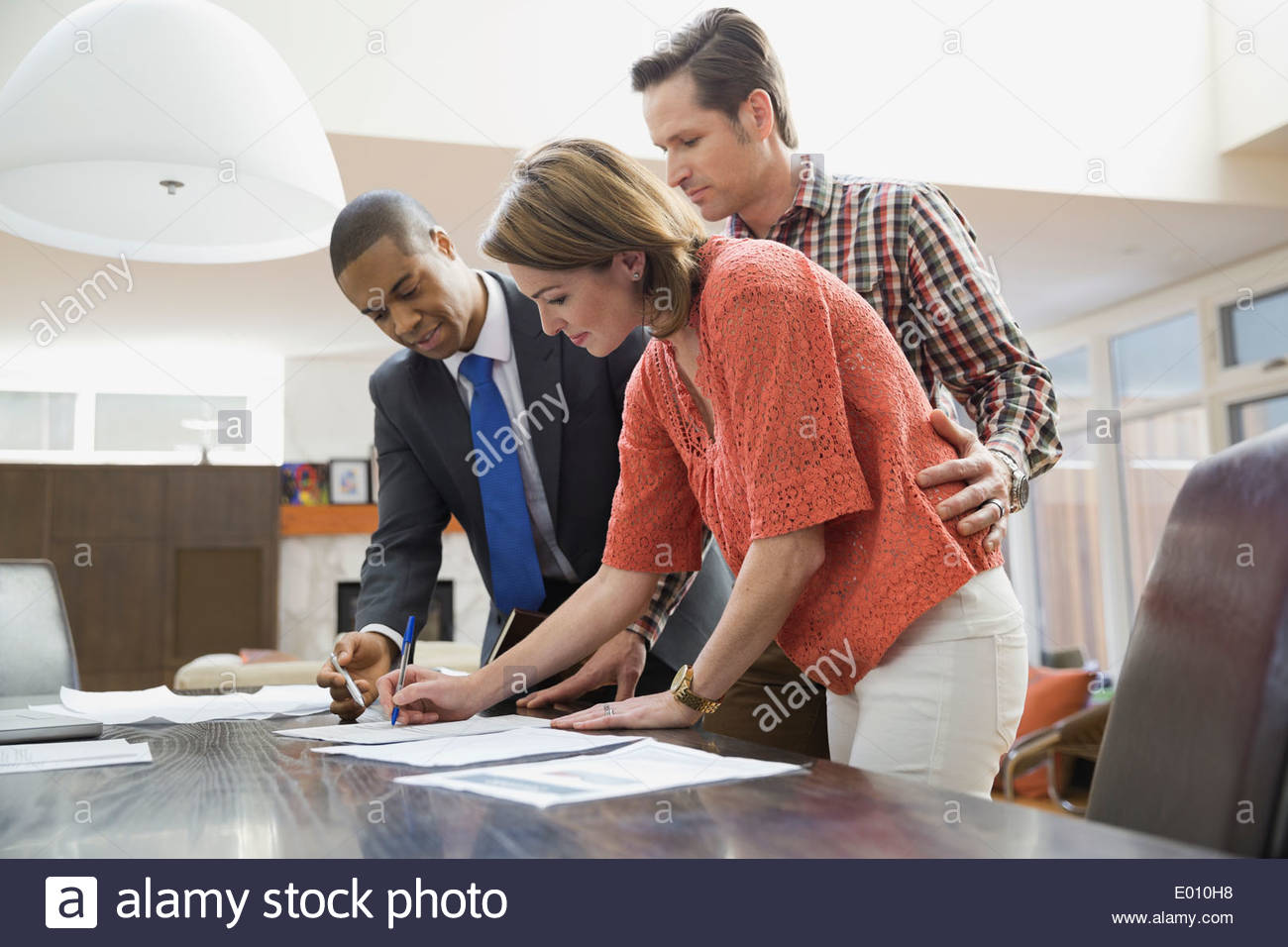 Couple signing documents for financial advisor Stock Photo
