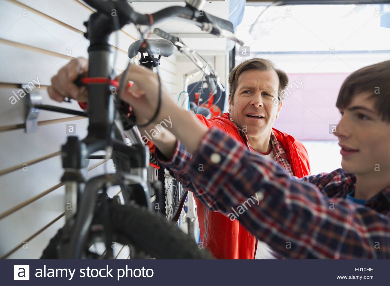 Father and son repairing bicycle in garage Stock Photo