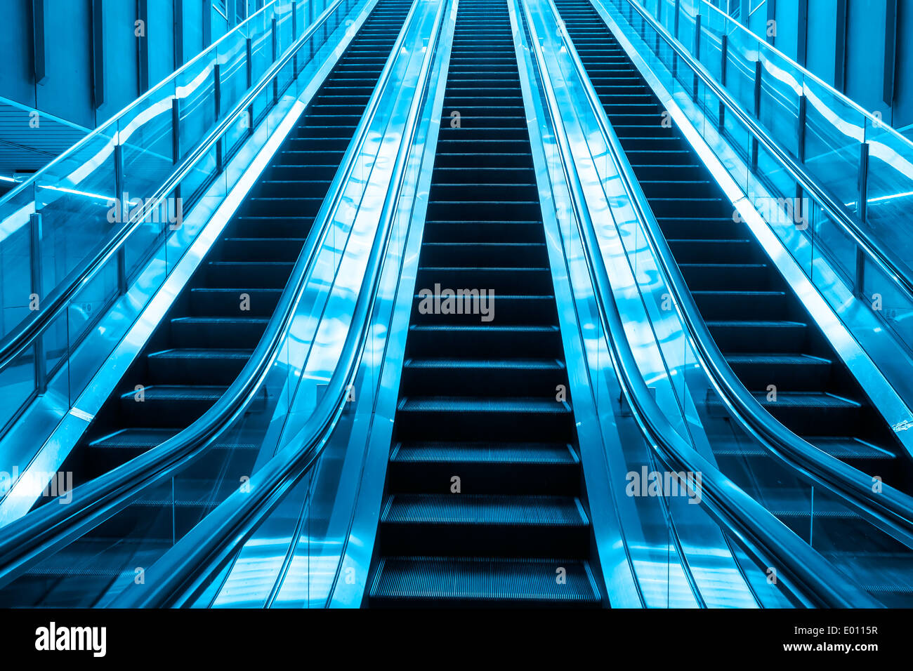 escalator blue two tone color going up stair in building Stock Photo