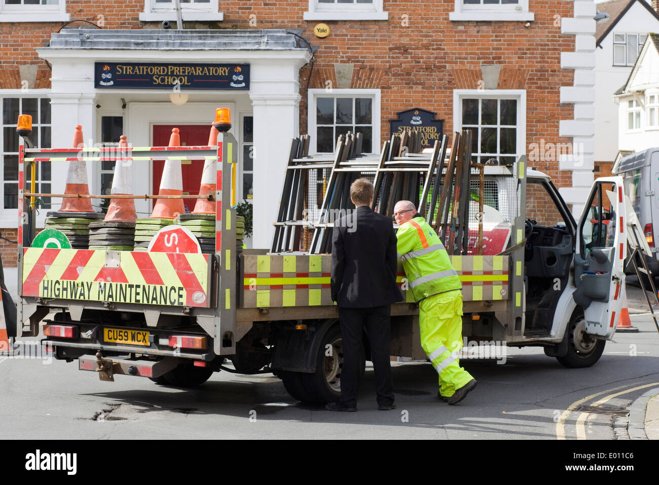 Highway maintenance workmen on a road getting information Stock Photo